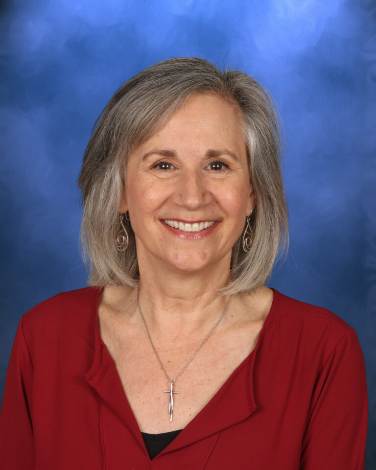 Maria Benevento, Campbell Christian Schools staff member, smiling in a warm campus setting