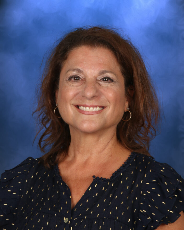 Karen Saloman, Campbell Christian Schools staff member, assisting students in a classroom setting