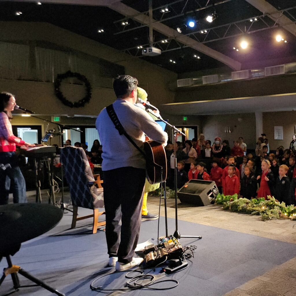 Student participating in a one-on-one music lesson, practicing an instrument with guidance from an instructor.