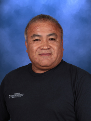 Jose Gutierrez, Campbell Christian Schools staff member, smiling in a classroom setting