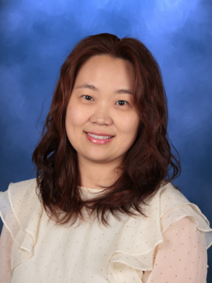 Clara Han, Campbell Christian Schools staff member, smiling in a classroom or school setting