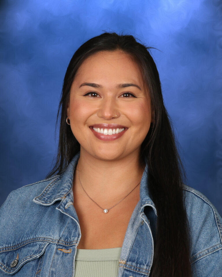 Catalina Bala, Campbell Christian Schools staff member, smiling in a welcoming campus environment