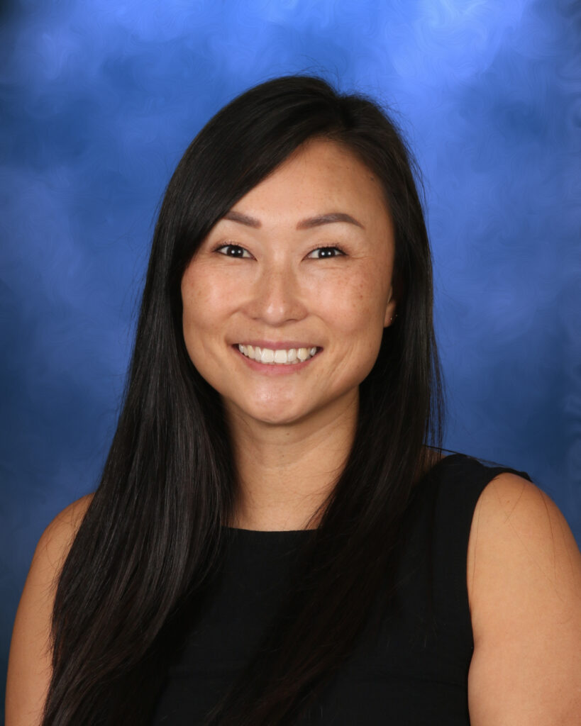 Helen Chang, Campbell Christian Schools staff member, smiling in a welcoming campus environment