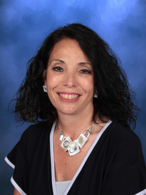 Jana Ghilardi, Campbell Christian Schools staff member, smiling in a bright and welcoming school setting