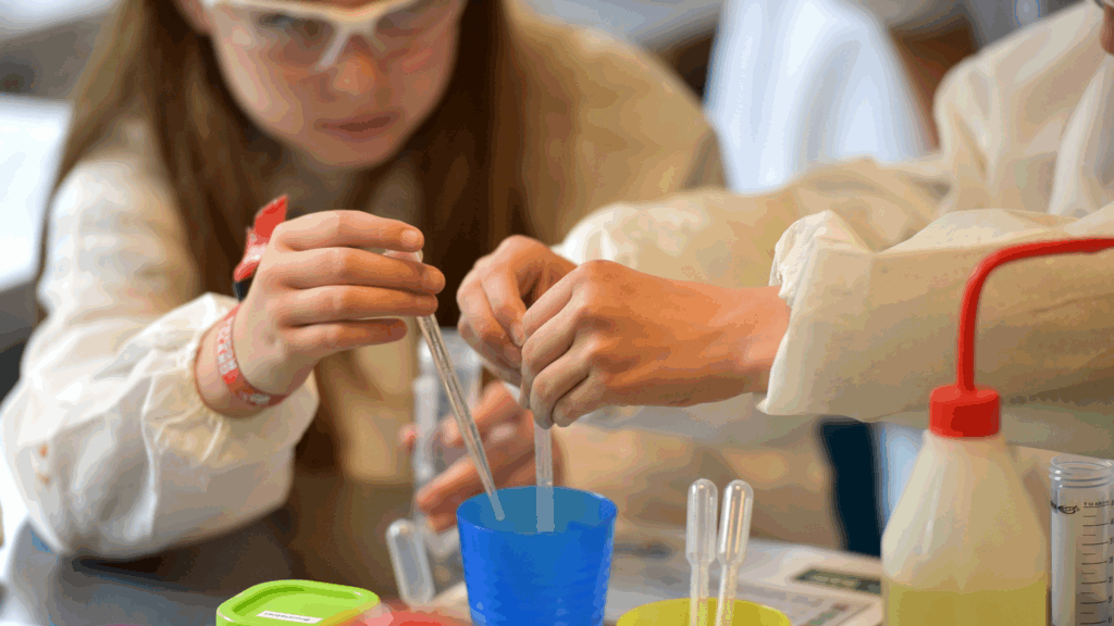 First grade students at Campbell Christian Schools conducting a hands-on science experiment with teacher guidance.