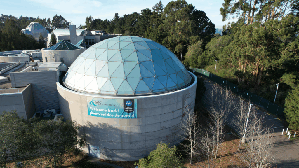Campbell Christian Schools students exploring astronomy exhibits and using telescopes at Chabot Space & Science Center.