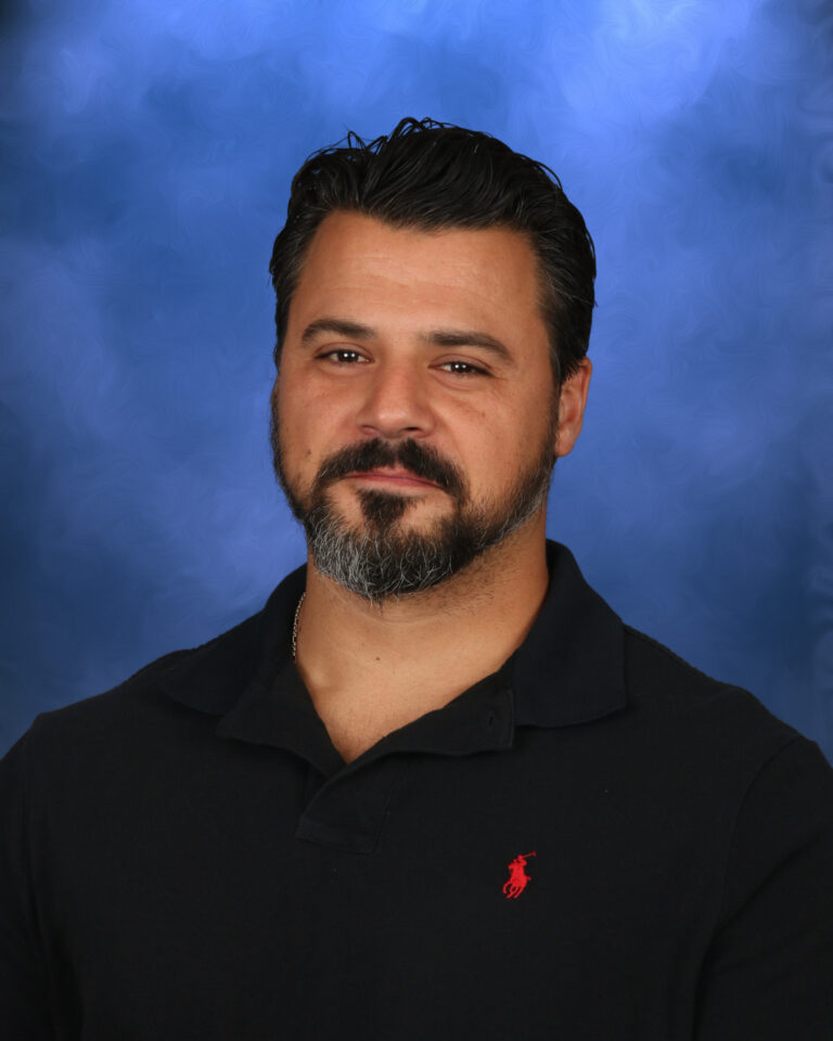 Theo Matheou, Campbell Christian Schools staff member, smiling in a classroom setting